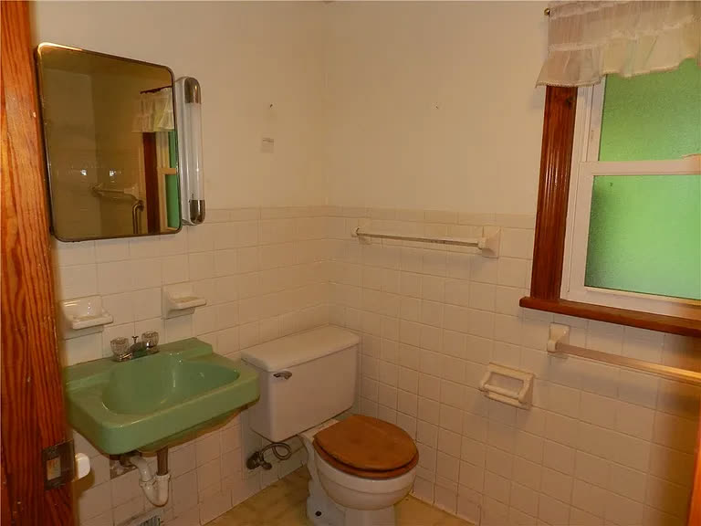 Bathroom before, dated green fixtures